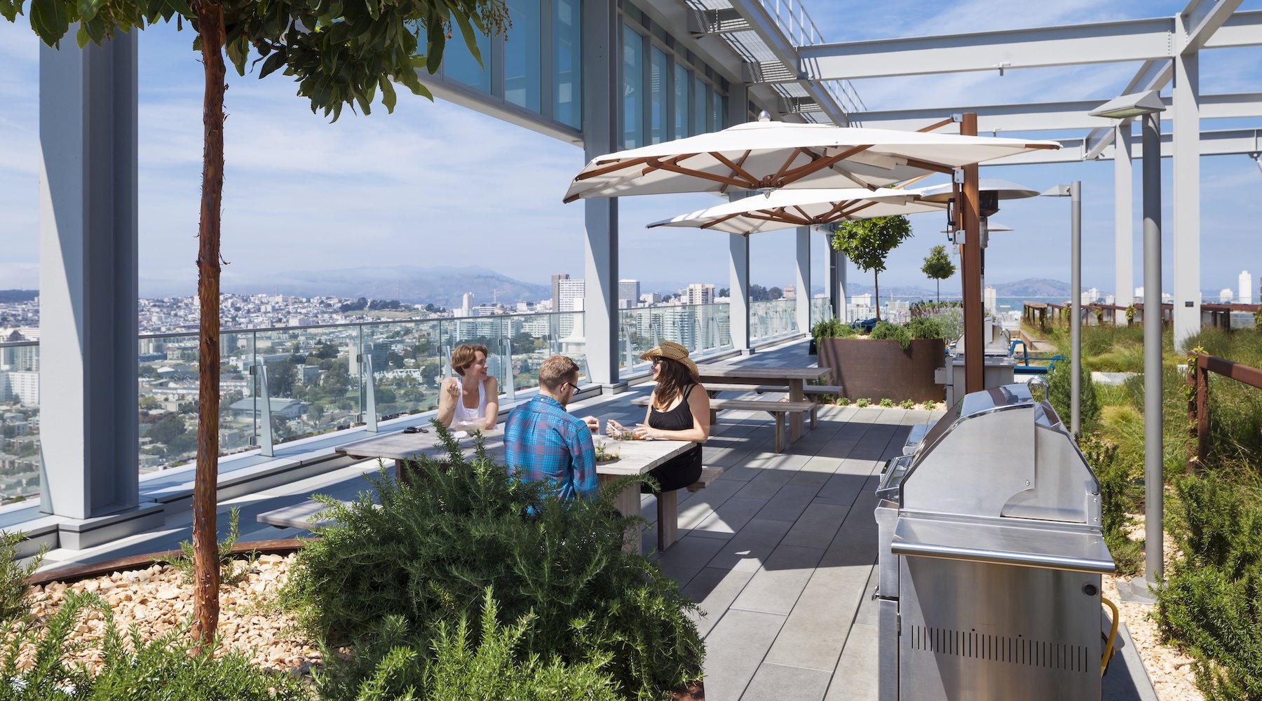 group of people sitting on a rooftop deck 