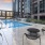a pool and chairs outside a building