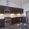 Spacious and well lit kitchen with wood flooring and stainless steel appliances