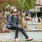 a person sitting on a bench with a dog