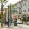 a street with palm trees and cars