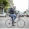a man riding a bicycle on a city street