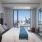 Large well lit bedroom with plush carpets and large windows 
