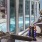 a person running on a treadmill with a pool view