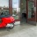 a red motorcycle parked outside a building